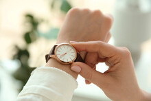 Woman With Luxury Wristwatch On Blurred Background, Closeup