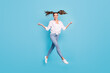 © deagreez - Full length body size view of attractive funky cheerful girl jumping having fun going enjoying isolated on bright blue color background