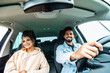 © F8  \ Suport Ukraine - Front view of indian couple man and woman sitting in car. Enjoying travel concept.