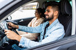 © F8  \ Suport Ukraine - leisure, road trip, travel, family and people concept. Young happy indian man and woman driving in car