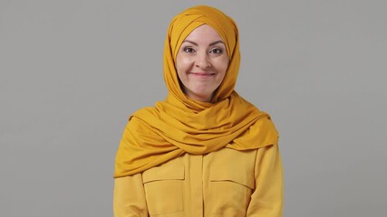 Wall Mural - Young fun shocked arabian asian muslim woman in abaya hijab yellow clothes surprised ask what wow omg put hands on face isolated grey gray background People uae middle eastern islam religious concept