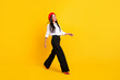 © deagreez - Full body profile side photo of nice happy lady walk empty space wear red beret isolated on yellow color background