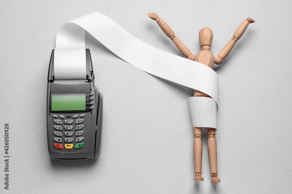 Payment terminal with wooden mannequin on light background