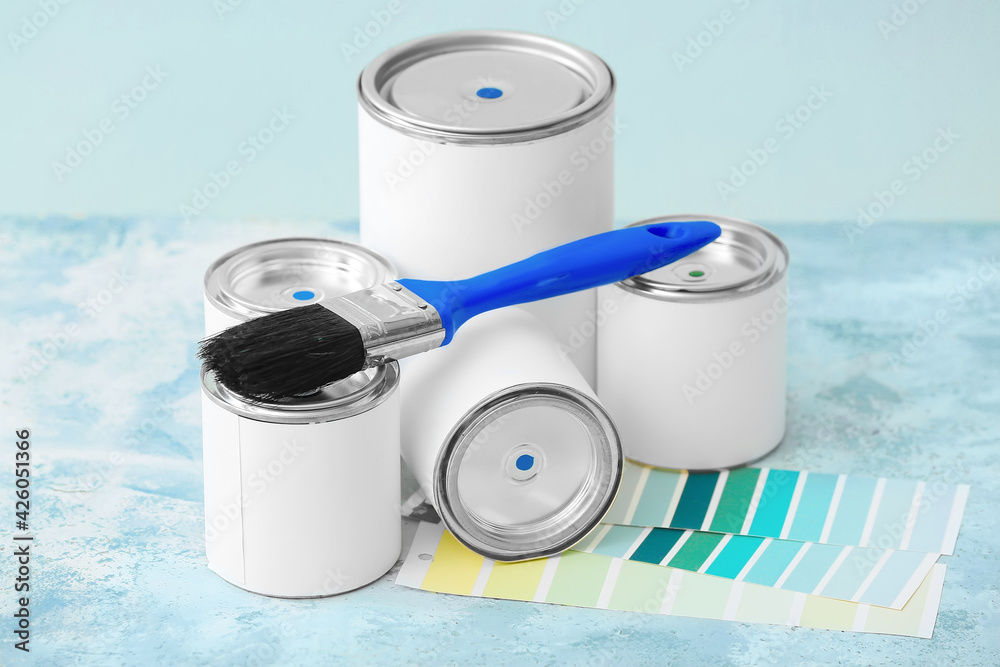 Cans of paints, brush and palette samples on color background - obrazy, fototapety, plakaty 