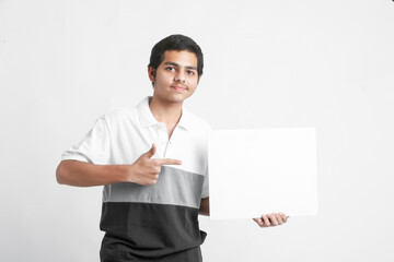 Canvas Print - Young indian college student showing white board on white background