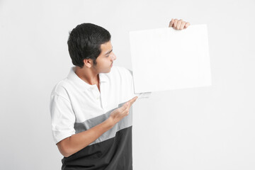 Canvas Print - Young indian college student showing white board on white background