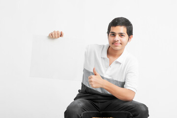 Canvas Print - Young indian college student showing white board on white background