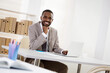 © chagin - Happy african american businessman smiling at camera in office