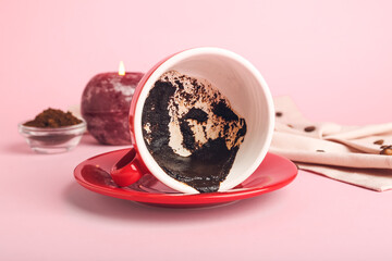 Cup with spent coffee grounds for fortune telling on color background