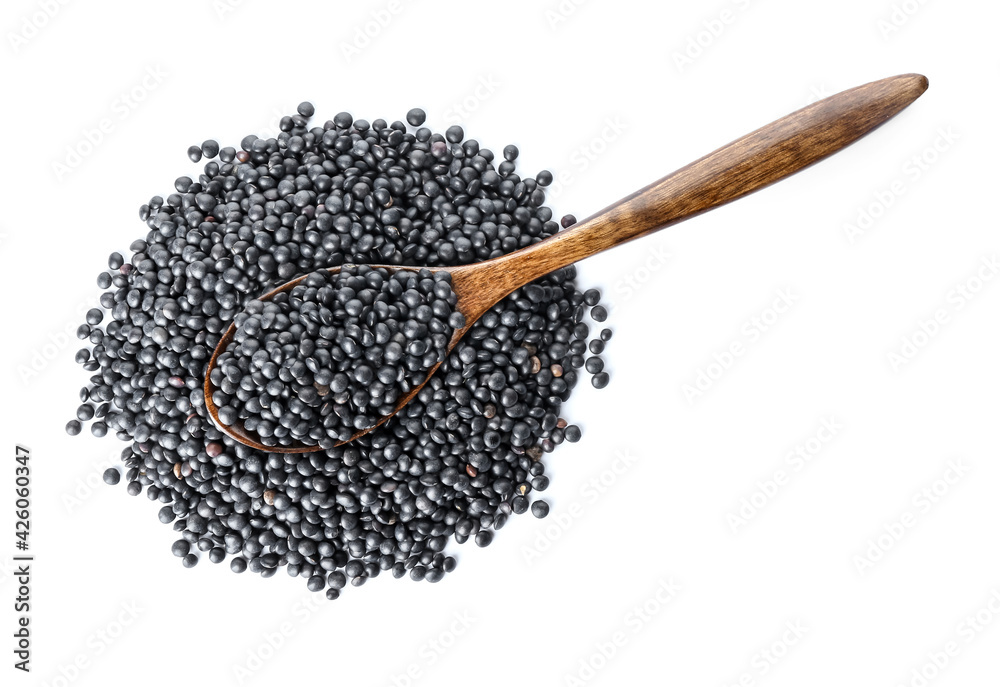 Spoon with black lentils on white background