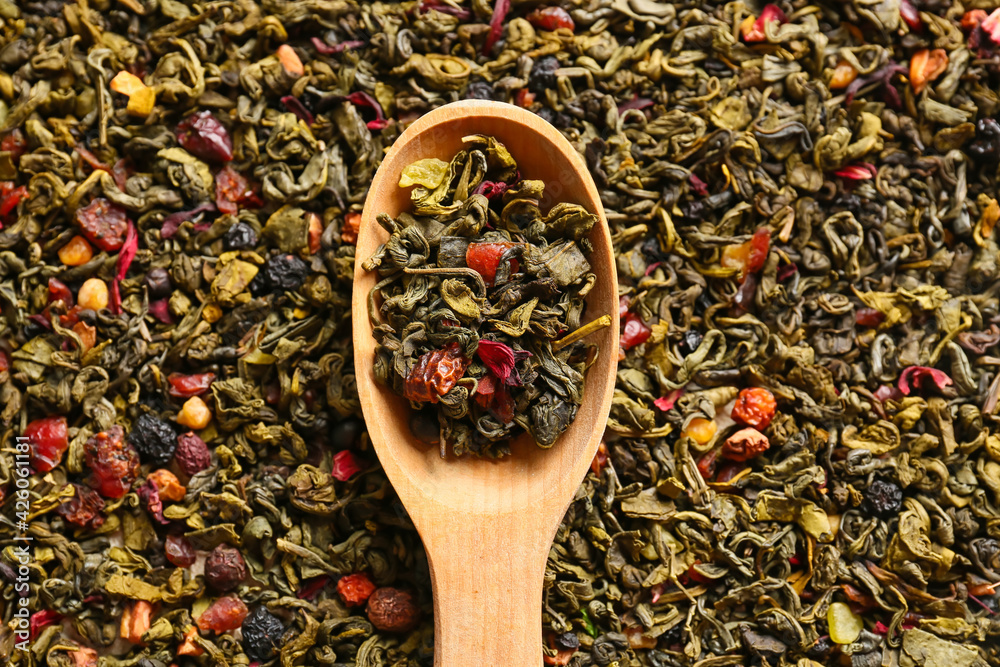 Spoon with dry green tea, closeup