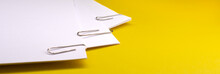 Metal Paper Clips Attached To A Blank White Paper