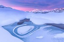 Crazy Shape In A Frozen Alpine Lake At Sunrise With View Of Mount Disgrazia, Valmalenco, Valtellina, Lombardy, Italy