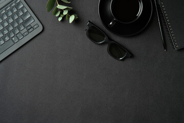 Fototapete - Top view creative workspace with laptop computer, cop of coffee, glasses and supplies on black leather background. Flat lay, view from above.