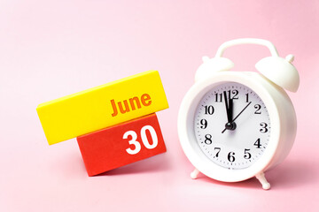 Wall Mural - June 30th. Day 30 of month, Calendar date.White alarm clock on pastel pink background. Summer month, day of the year concept.