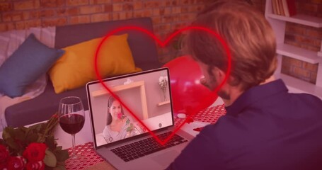 Poster - Red neon heart outline against caucasian man waving while having a video call on laptop