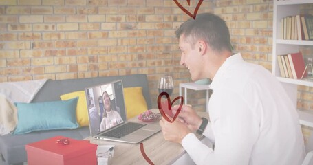 Poster - Heart icons over caucasian man holding a heart shaped placard while having a video call on laptop