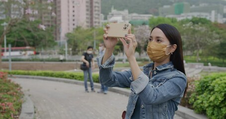 Poster - Woman wear face mask and use of smart phone to take photo