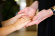 © Tetra Images - Close-up of grandmother and granddaughter (8-9) holding hands