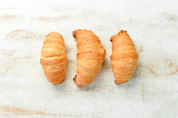 Wall Mural - Fresh French croissants with chocolate. Baking from rye and flour. Top view. Rustic style.