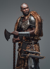 Proud warrior from the past in fur and armour holding a combat axe