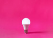 Glowing light bulb on magenta background. Discovery, invention, new idea concept.