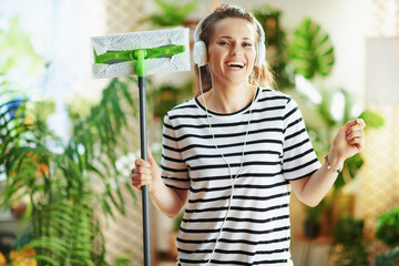 happy housewife at home in sunny day doing household work