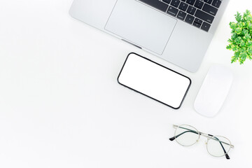 Wall Mural - Top view Working space laptop with keyboard , grasses and smartphone isolated on white background with copy space