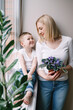 © Олег Кошевський - mom with little son in the white kitchen