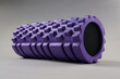 Purple foam Massage roller on gray background