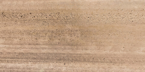 Wall Mural - view from above on car tire tracks on texture of gravel road