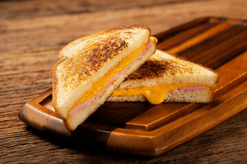 Grilled ham and cheese. Sandwich with cheese and ham on grill.