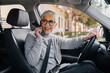 © bnenin - Portrait of a beautiful senior woman having a phone call while driving a car.