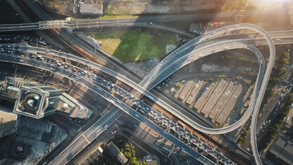 Wall Mural - Beautiful aerial timelapse of multi-level highway in Moscow on a sunny evening. Big road junction with a lot of traffic illuminated by the sunset sun.