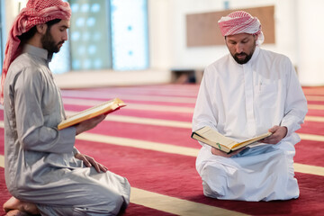 Wall Mural - two muslim people in mosque reading quran together concept of islamic education