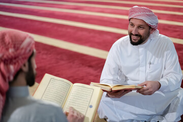 Wall Mural - two muslim people in mosque reading quran together concept of islamic education