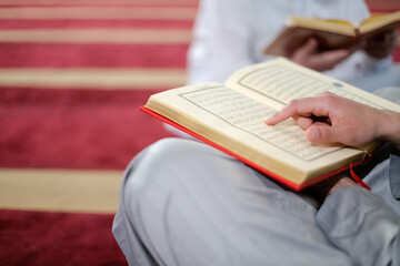 two muslim people in mosque reading quran together concept of islamic education