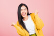 © sorapop - Happy Asian portrait beautiful cute young woman standing winning and surprised excited screaming open mouth raise hands, studio shot isolated pink background, Thai female wow with copy space