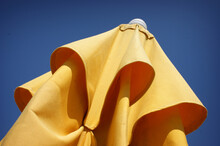 Bright Yellow Umbrella With Blue Sky