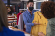 © Wavebreak Media - Diverse group of creative colleagues wearing face masks brainstorming in meeting room