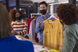 © Wavebreak Media - Diverse group of creative colleagues wearing face masks brainstorming in meeting room