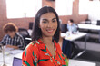 © Wavebreak Media - Portrait of mixed race businesswoman at the office looking to camera smiling