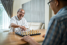 Asian Old Man Enjoy Playing Chess Together With Friend In Nursing Home