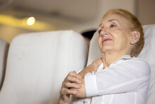 Health Problem On An Airplane, The Senior Female Passenger On The Plane Felt Shoulder Pain From A Long Plane Ride