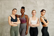 © Drazen - Portrait of confident diverse female athletes against the wall looking at camera.