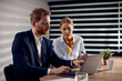 © Drazen - Business colleagues cooperating while working on laptop in the office.