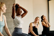 Happy black woman having fun with female friends during exercise class at health club.