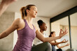 © Drazen - Below view of athletic woman doing relaxation exercise while working out at health club.