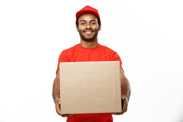 Poster - Delivery Concept - Portrait of Happy African American delivery man in red cloth holding a box package. Isolated on white studio Background. Copy Space