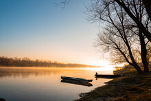Mesmerizing Shot Of Boats On The Calm Lake Water At Sunrise